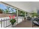 Covered patio overlooks a beautiful backyard space with seating and mature landscaping at 304 34Th W St, Bradenton, FL 34205