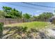 Grassy backyard is surrounded by a tall wooden fence providing privacy to the home at 304 34Th W St, Bradenton, FL 34205