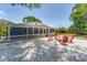 Home exterior features a white picket fence, backyard area, and red patio furniture at 304 34Th W St, Bradenton, FL 34205