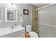 Bathroom with glass shower, white sink and toilet with a towel and decorative frame at 304 34Th W St, Bradenton, FL 34205