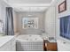 Bright bathroom featuring a large soaking tub with tiled surround at 304 34Th W St, Bradenton, FL 34205