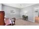 Bedroom features carpet, a ceiling fan, two desks, a window, and a wooden chair at 304 34Th W St, Bradenton, FL 34205