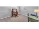 Neutral-toned bedroom with carpet, two windows, desk and chair set, and a lamp at 304 34Th W St, Bradenton, FL 34205