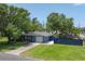 Charming single-story home with a well-maintained lawn, blue fence, and mature trees at 304 34Th W St, Bradenton, FL 34205
