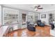 Sunroom with terra cotta tile, ceiling fan, large windows, and two reclining chairs at 304 34Th W St, Bradenton, FL 34205