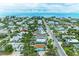 Stunning aerial view of a coastal community, showcasing charming homes and breathtaking ocean vistas at 315 Magnolia Ave, Anna Maria, FL 34216