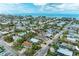 Picturesque aerial view showcases a vibrant coastal community with colorful homes and lush palm trees near the ocean at 315 Magnolia Ave, Anna Maria, FL 34216
