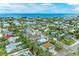Charming aerial view showcases a vibrant coastal community, highlighting colorful houses and tropical foliage by the ocean at 315 Magnolia Ave, Anna Maria, FL 34216