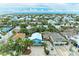 Scenic aerial shot capturing colorful coastal homes nestled amidst lush tropical foliage, offering a tranquil waterfront lifestyle at 315 Magnolia Ave, Anna Maria, FL 34216