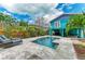 Charming backyard oasis with a sparkling pool, lush landscaping, and an inviting two-story home at 315 Magnolia Ave, Anna Maria, FL 34216