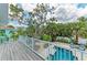 Deck with a serene view of the private pool and lush greenery at 315 Magnolia Ave, Anna Maria, FL 34216