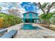 Charming two-story home with a backyard pool and lush greenery, perfect for relaxing and entertaining at 315 Magnolia Ave, Anna Maria, FL 34216
