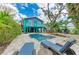 Beautiful backyard oasis with a pool, lush greenery, and a charming two-story home at 315 Magnolia Ave, Anna Maria, FL 34216