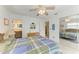 Large bedroom with light-colored walls and tile floors, ceiling fan, with a mirror reflecting another bedroom at 315 Magnolia Ave, Anna Maria, FL 34216