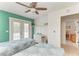 Charming bedroom with a ceiling fan, balcony access, and a peek into the hallway at 315 Magnolia Ave, Anna Maria, FL 34216