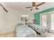 Bright bedroom boasts two twin beds, a ceiling fan, and access to a private balcony at 315 Magnolia Ave, Anna Maria, FL 34216