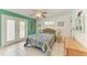 Bedroom featuring a large window with views of the backyard, with a ceiling fan and decorative dresser at 315 Magnolia Ave, Anna Maria, FL 34216