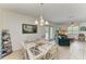Dining area connects the living room and kitchen with tile flooring and inviting furniture at 315 Magnolia Ave, Anna Maria, FL 34216