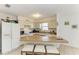 Bright kitchen featuring a breakfast bar, white cabinets, and ample counter space for cooking at 315 Magnolia Ave, Anna Maria, FL 34216