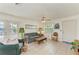 Well-lit living room featuring cozy seating, tile flooring, and direct access to the porch at 315 Magnolia Ave, Anna Maria, FL 34216