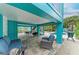Inviting outdoor living area with comfortable seating, dining, and a grill next to the sparkling pool at 315 Magnolia Ave, Anna Maria, FL 34216