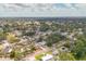 Discover the neighborhood with this aerial view of single-Gathering homes and lush green trees at 3328 Kingswood Dr, Sarasota, FL 34232