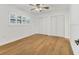 Minimalist bedroom with modern window shutters, wood floors, ceiling fan, and a large closet at 3328 Kingswood Dr, Sarasota, FL 34232