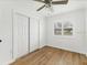 Bedroom featuring hardwood floors, ceiling fan, closet, and natural light at 3328 Kingswood Dr, Sarasota, FL 34232