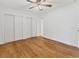 Bedroom with sleek wood floors, large windows and doors, ceiling fan, and a large closet at 3328 Kingswood Dr, Sarasota, FL 34232