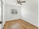 Bedroom boasts hardwood floors, ceiling fan, and natural light from window at 3328 Kingswood Dr, Sarasota, FL 34232