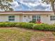 Charming single-story home featuring a well-manicured lawn and mature landscaping at 3328 Kingswood Dr, Sarasota, FL 34232