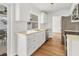 Modern kitchen featuring white cabinets, stainless steel appliances, and a view of the patio at 3328 Kingswood Dr, Sarasota, FL 34232