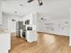 Bright kitchen featuring white cabinets and stainless steel appliances adjacent to living room at 3328 Kingswood Dr, Sarasota, FL 34232