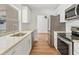 Modern kitchen with white cabinets and stainless steel appliances at 3328 Kingswood Dr, Sarasota, FL 34232