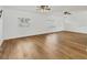 Bright and spacious living room featuring hardwood floors, fans, and lots of natural light at 3328 Kingswood Dr, Sarasota, FL 34232