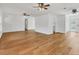 Open living area with hardwood floors leading to the kitchen and pool at 3328 Kingswood Dr, Sarasota, FL 34232