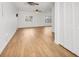 Spacious living room featuring wood floors, a ceiling fan, and access to the backyard at 3328 Kingswood Dr, Sarasota, FL 34232