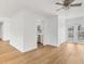 Open living space featuring sleek wood floors, a ceiling fan, and access to the kitchen at 3328 Kingswood Dr, Sarasota, FL 34232