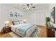 Comfortable main bedroom with a plush bed, ceiling fan, and natural light at 3328 Kingswood Dr, Sarasota, FL 34232