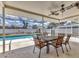 Covered patio with dining table and chairs next to pool at 3328 Kingswood Dr, Sarasota, FL 34232