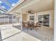 Covered patio with dining table and chairs next to back entrance at 3328 Kingswood Dr, Sarasota, FL 34232