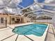 Backyard pool surrounded by screened enclosure and patio with a dining set at 3328 Kingswood Dr, Sarasota, FL 34232