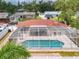 Enjoy the view of the in-ground screened pool perfect for hot summer days from above at 3328 Kingswood Dr, Sarasota, FL 34232