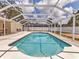 Backyard pool surrounded by screened enclosure at 3328 Kingswood Dr, Sarasota, FL 34232