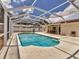 Backyard pool surrounded by screened enclosure and patio with a dining set at 3328 Kingswood Dr, Sarasota, FL 34232