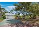Charming single-story home with a well-maintained lawn, mature trees, and a driveway at 335 Arthur Dr, Sarasota, FL 34236
