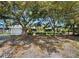Charming single-story home with mature trees, attached garage, and a well-manicured lawn at 335 Arthur Dr, Sarasota, FL 34236