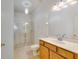 Bright bathroom featuring a glass shower, vanity, and tile flooring at 3402 Parkridge Cir, Sarasota, FL 34243