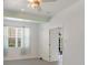 Bedroom with light walls and light-colored hardwood flooring and view to back patio at 3402 Parkridge Cir, Sarasota, FL 34243