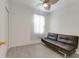 Cozy bedroom with dark futon, window, and light walls and flooring at 3402 Parkridge Cir, Sarasota, FL 34243